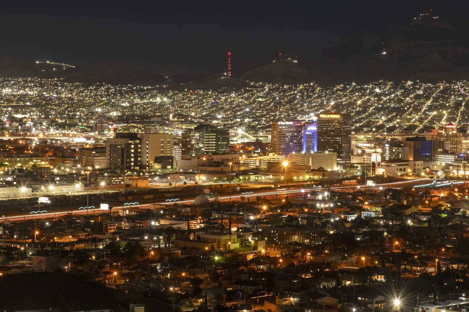 El Paso at night, with the lights of Ciudad Ju&aacute;rez rising on the hillside beyond downtown